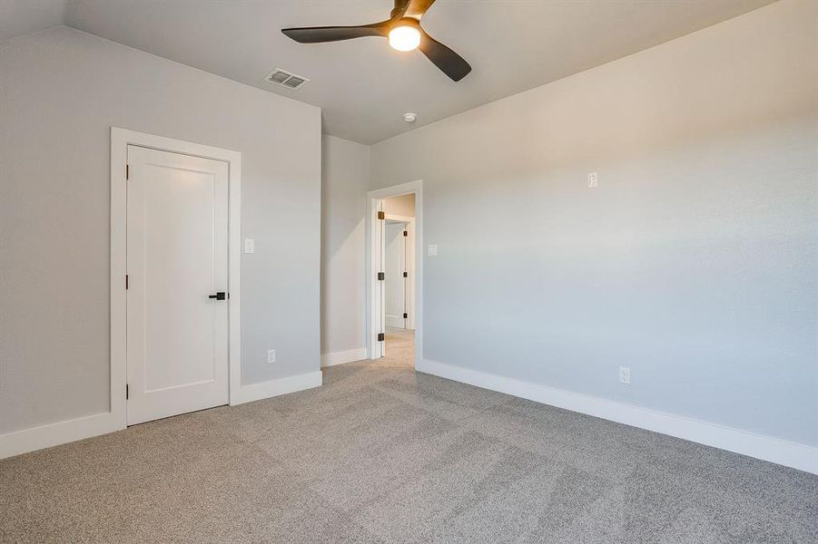 Unfurnished bedroom featuring carpet and a ceiling fan
