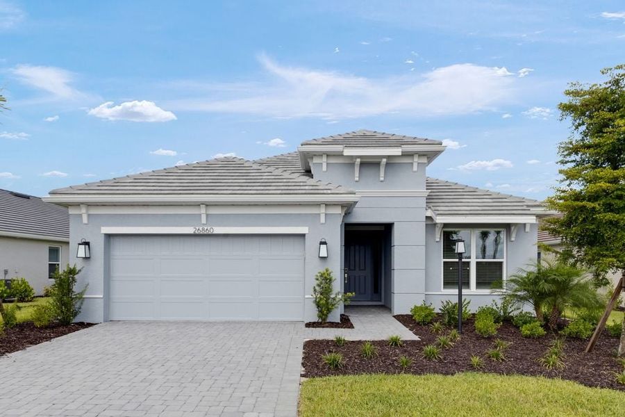 Front exterior of a new home in Esplanade at Starling, Punta Gorda, FL, highlighting curb appeal (Image 1).