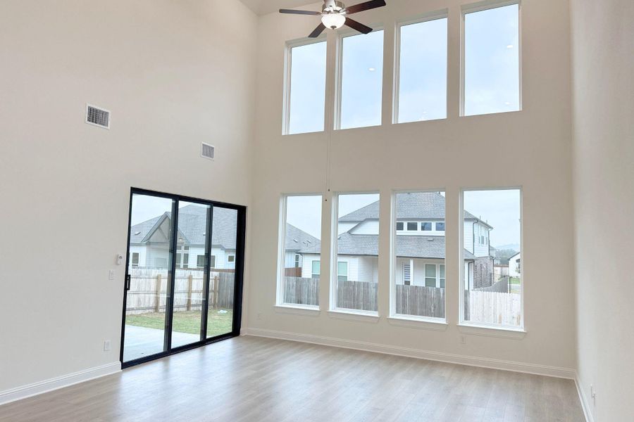 Unfurnished living room with a ceiling fan and light wood finished floors