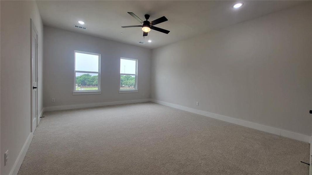 Spare room with light carpet, a ceiling fan, visible vents, and recessed lighting