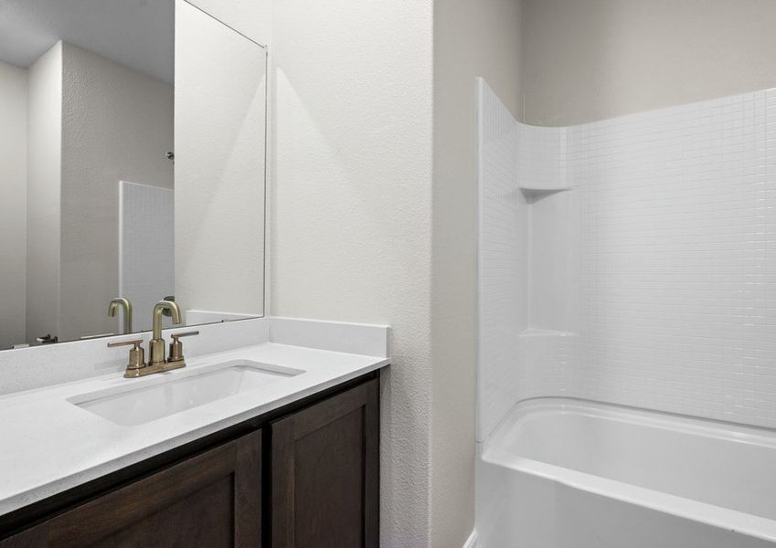 The secondary bathroom has a sprawling vanity and shower-tub combo. The secondary bathroom has a sprawling vanity and shower-tub combo.