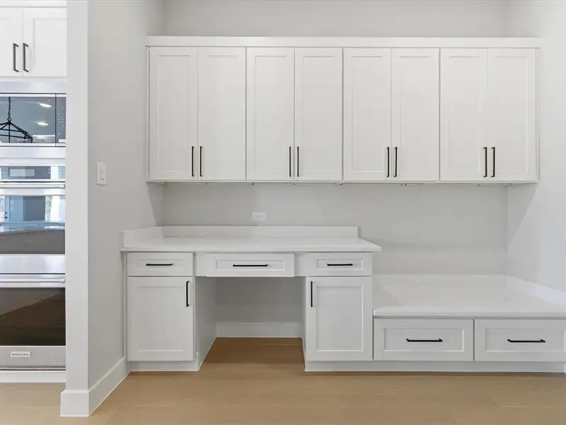 Unfurnished office featuring light wood-style flooring and baseboards