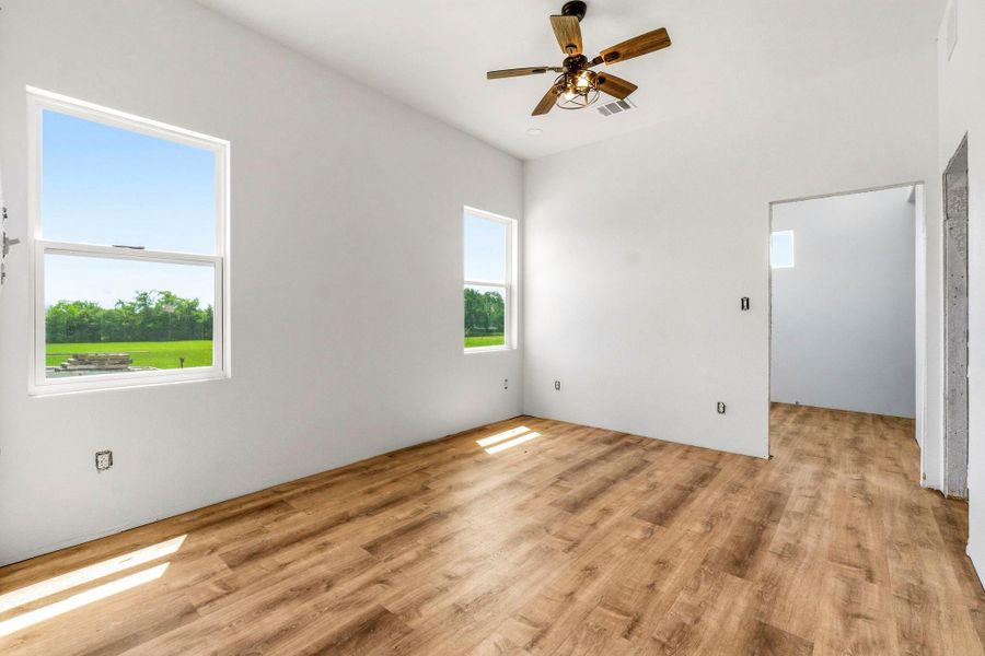 Primary suite with access to large walk-in closet and ensuite.