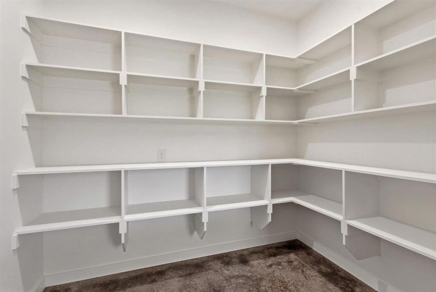 The property features an expansive corner pantry with extensive built-in shelving, providing ample storage solutions