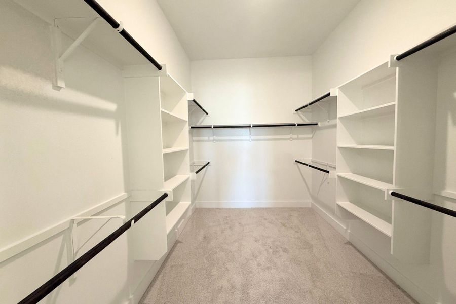 Ample closet space with built-in shelving and hanging rods for organized storage. Ample closet space with built-in shelving and hanging rods for organized storage.