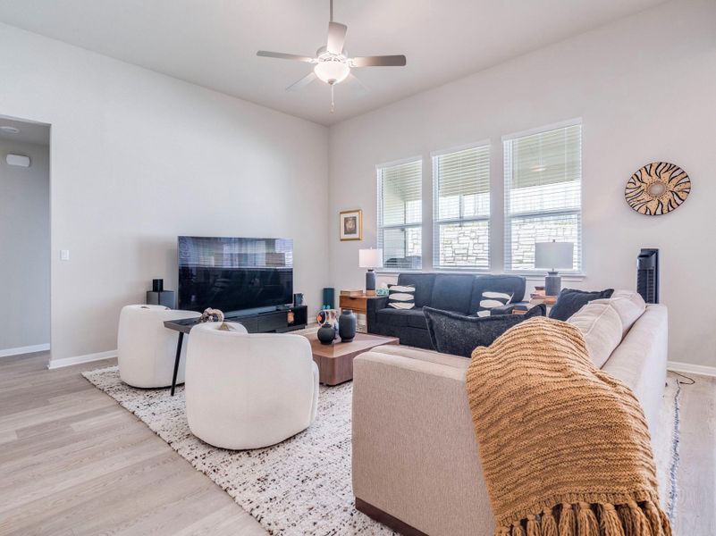 A well-lit gathering space offers ample seating and durable wood flooring for everyday comfort.
