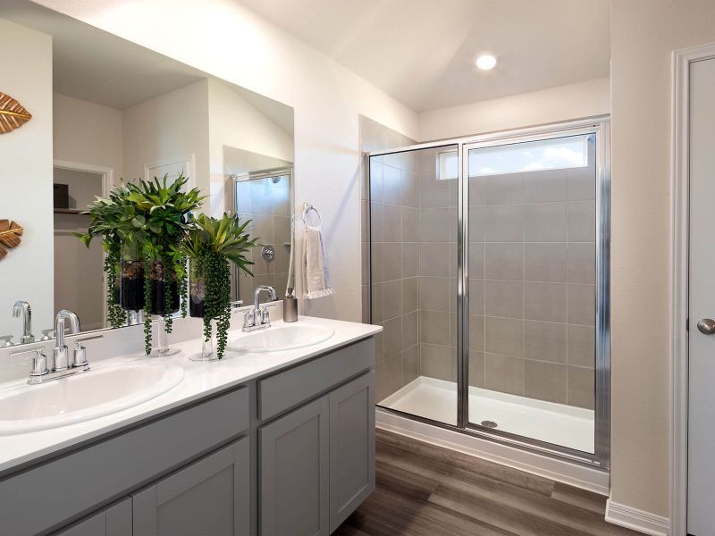 Enjoy dual sinks and an oversized walk-in shower in your new primary bathroom.