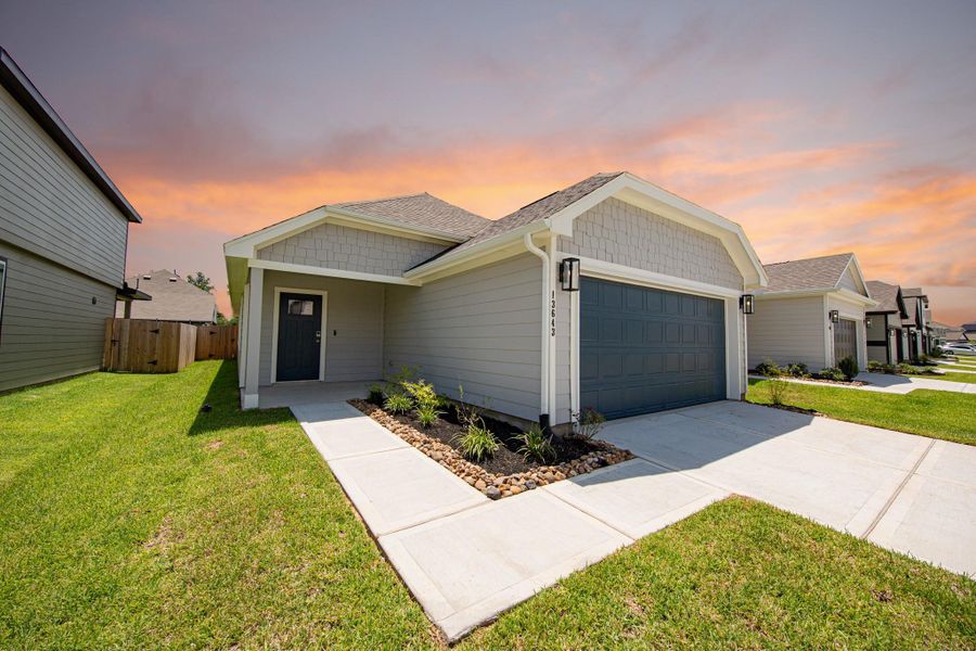 Front exterior of a new home in Townsend Reserve, Splendora, TX, highlighting curb appeal (Image 2).