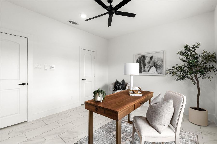 Versatile bedroom featuring spacious walk-in closet - perfect as a guest bedroom or home office. Sleek tile floors and modern finishes complete the polished look.