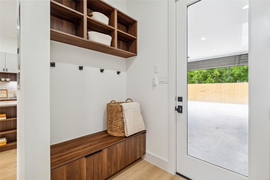 This stylish mudroom nook offers everyday convenience with built-in seating, storage, and wall hooks—perfect for keeping life organized in a beautifully designed space.