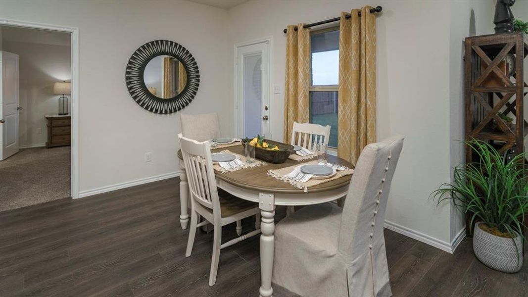 Dining space with baseboards and dark wood-style floors