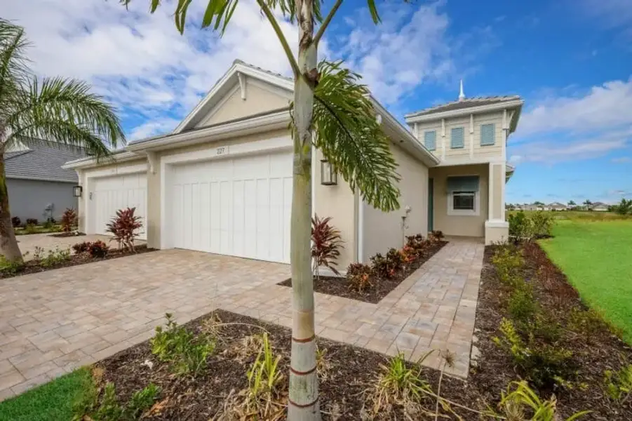 Representative exterior photo of a completed home built from the Boca Grande by Medallion Home in Reflection Villas at Watercolor Place, Bradenton, FL (Image 16).