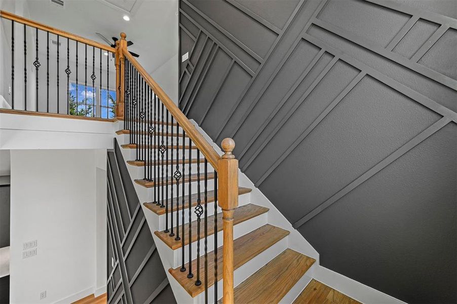 Stairway featuring hardwood / wood-style flooring