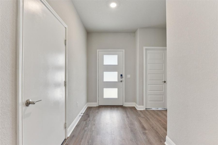 Entrance foyer featuring wood finished floors and baseboards Entrance foyer featuring wood finished floors and baseboards