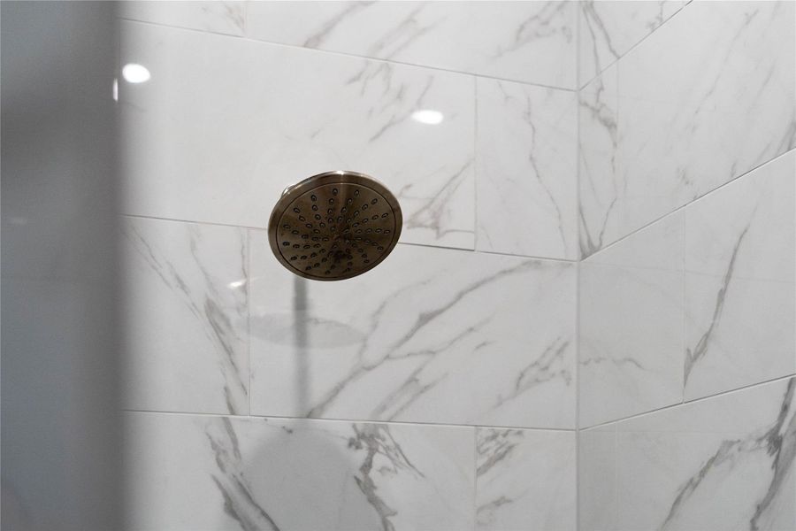 A luxurious rainfall shower head provides a spa-quality experience. A luxurious rainfall shower head provides a spa-quality experience.