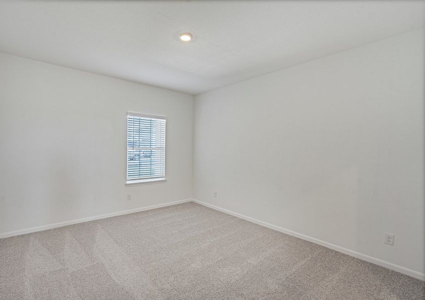Downstairs master bedroom with carpet flooring