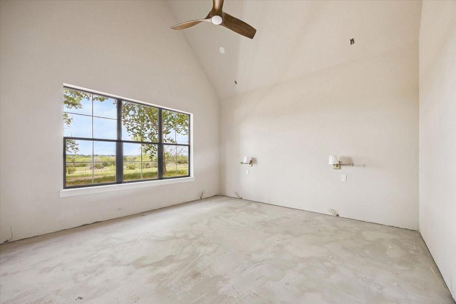 Primary bedroom with bedside lamps, vaulted ceiling with beam. Breathtaking view from every room
