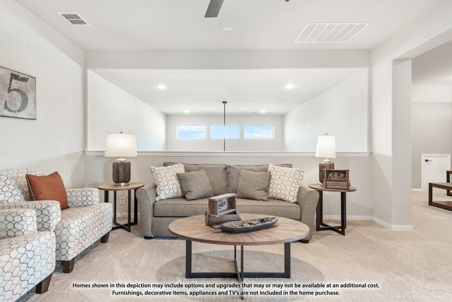 Carpeted living room with gray sofa, round wood coffee table, and clerestory windows near ceiling