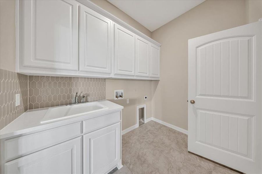 Washroom with hookup for an electric dryer, hookup for a washing machine, and cabinet space Washroom with hookup for an electric dryer, hookup for a washing machine, and cabinet space