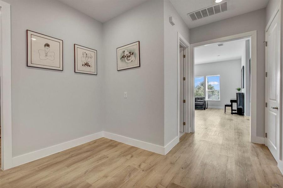 Hall featuring baseboards and light wood-style floors