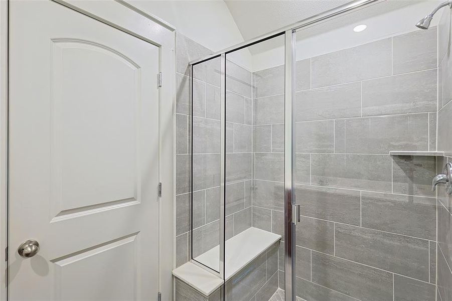 Bathroom featuring a shower with door