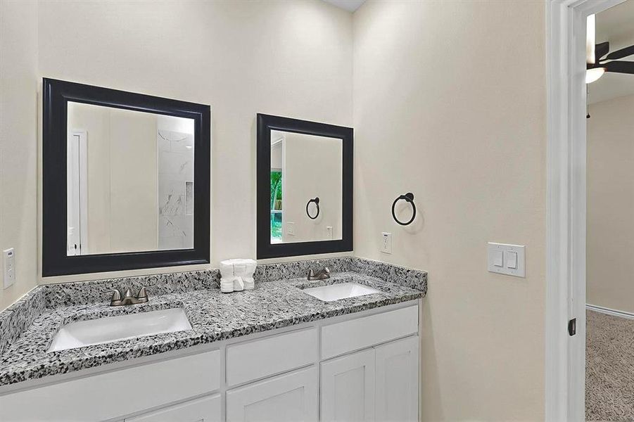 Bathroom featuring a sink and double vanity Bathroom featuring a sink and double vanity