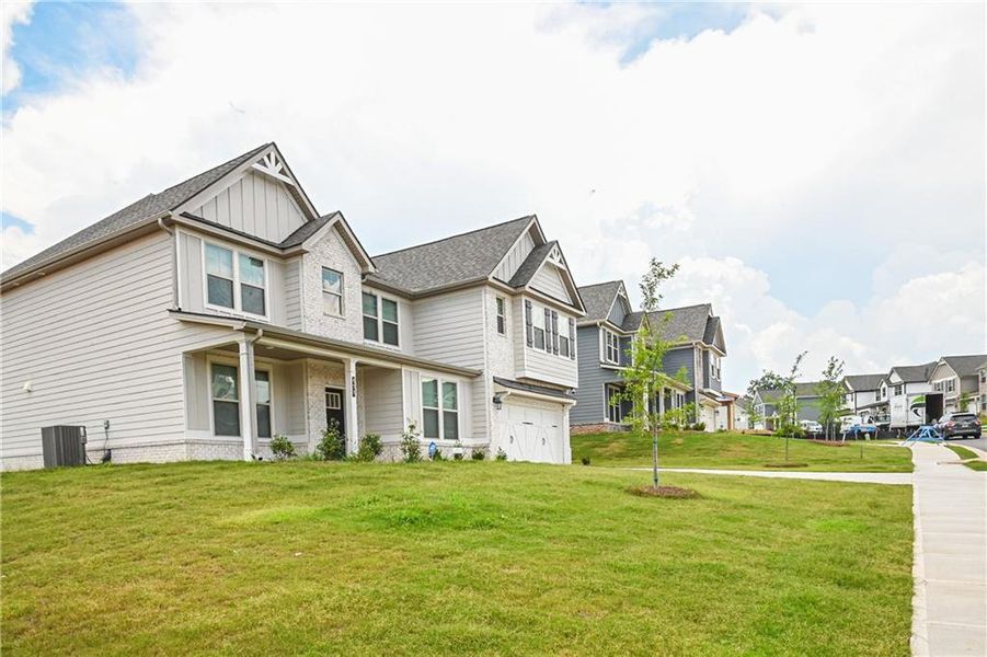 Front exterior of a new home in , Stockbridge, GA, highlighting curb appeal (Image 34).