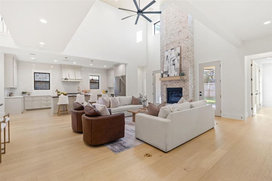 From this angle, your dramatic floor-to-ceiling brick fireplace becomes the focal point, anchoring the living space while framing sightlines straight into the kitchen. Whether you’re hosting friends or enjoying a quiet night in, everything stays connected without sacrificing visual impact.