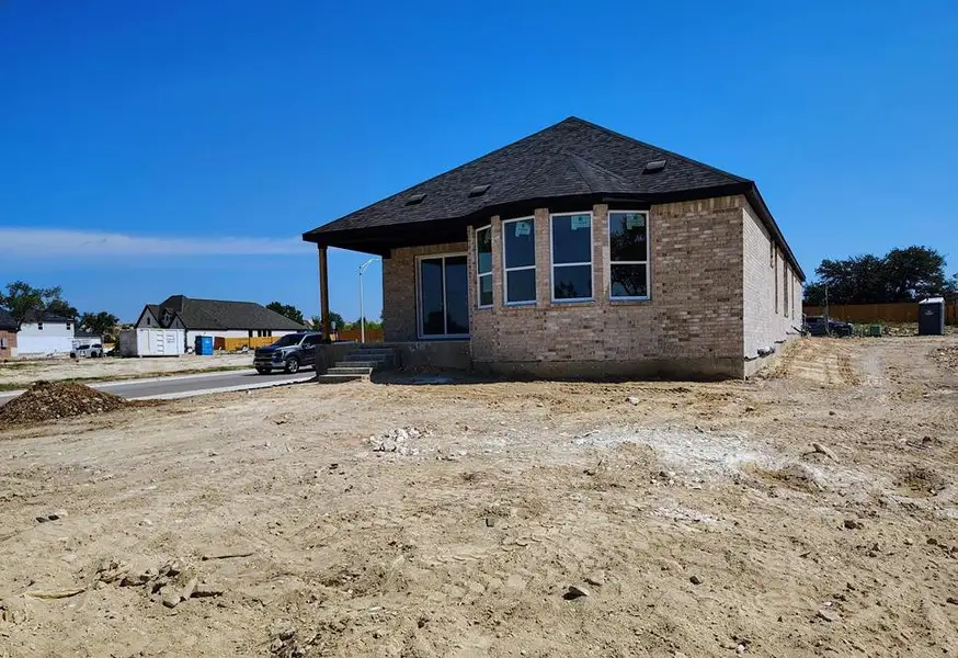 Front exterior of a new home in Woodside, Georgetown, TX, highlighting curb appeal (Image 2).