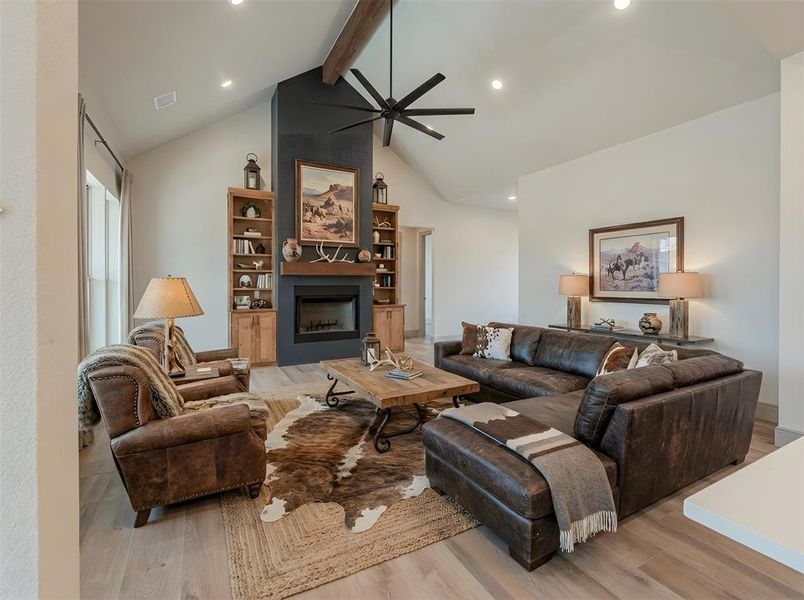 Living room that was built for entertaining with built ins and a wood burning fireplace