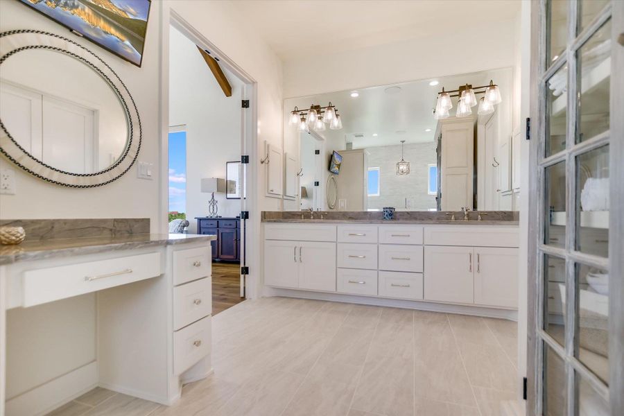Bathroom featuring double vanity, plenty of natural light, a shower, and recessed lighting Bathroom featuring double vanity, plenty of natural light, a shower, and recessed lighting