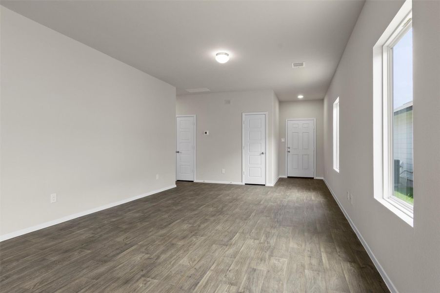 Empty room with dark wood-style floors and recessed lighting Empty room with dark wood-style floors and recessed lighting
