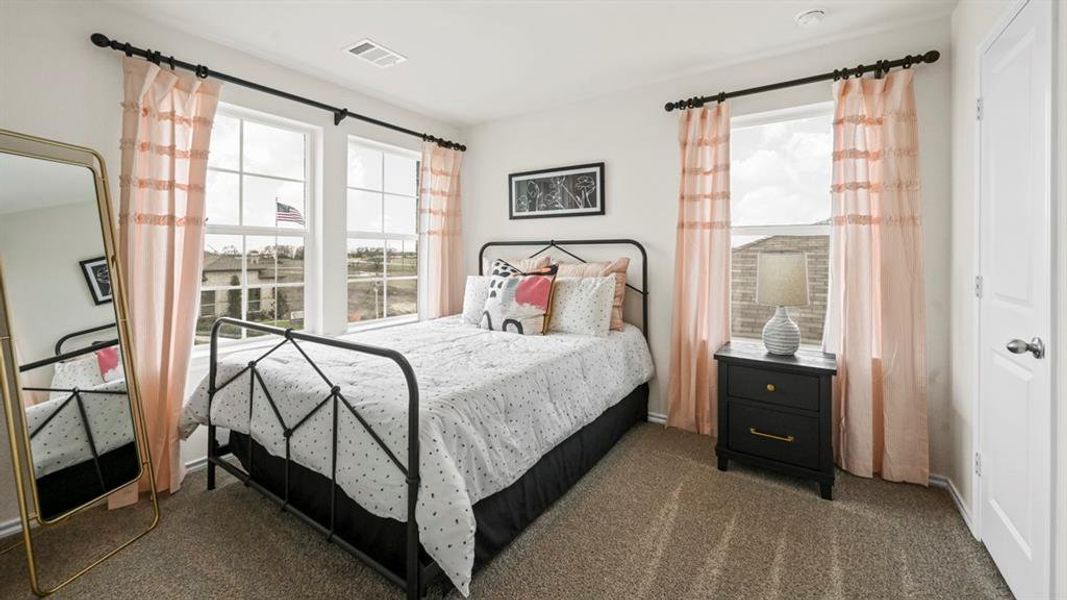 Bedroom featuring dark colored carpet