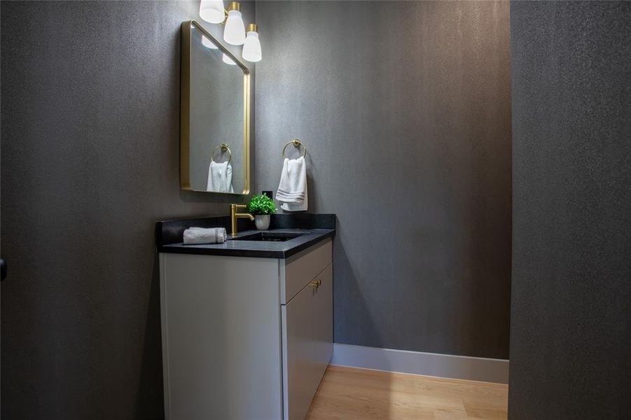 Bathroom with vanity and wood-type flooring