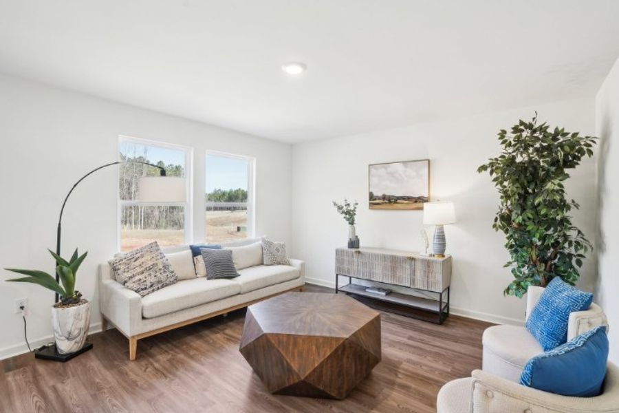 A living room with a white couch and blue pillows. A living room with a white couch and blue pillows.