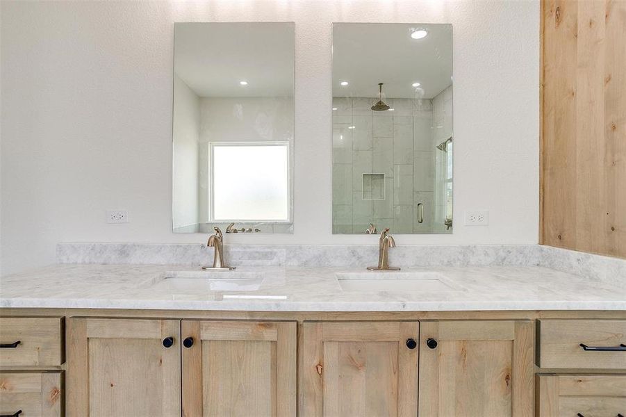 Bathroom with vanity and a shower with door