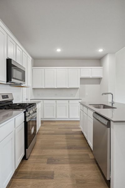 Kitchen in the Masters home plan by Trophy Signature Homes – REPRESENTATIVE PHOTO