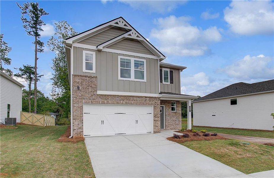 Front exterior of a new home in Abbotts Crossing, Conyers, GA, highlighting curb appeal (Image 2). Front exterior of a new home in Abbotts Crossing, Conyers, GA, highlighting curb appeal (Image 2).