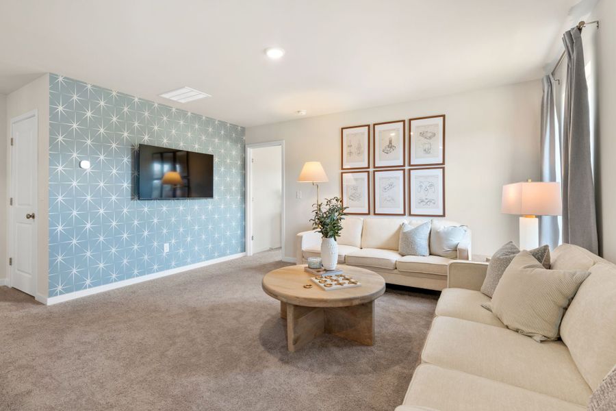 A living room with a couch and a coffee table. A living room with a couch and a coffee table.