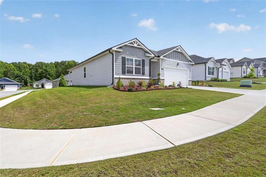 Front exterior of a new home in Champion's Run, Lithonia, GA, highlighting curb appeal (Image 2).