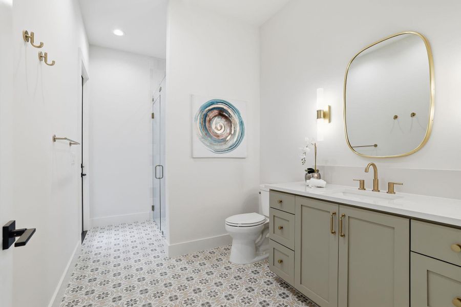 Full bath featuring vanity, a stall shower, recessed lighting, and light flooring