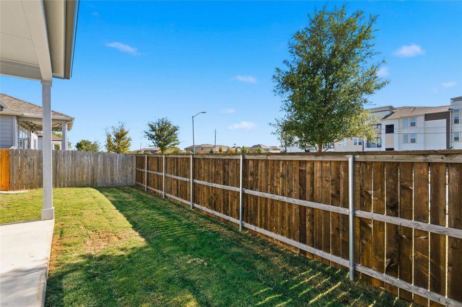 Fenced backyard featuring a residential view Fenced backyard featuring a residential view