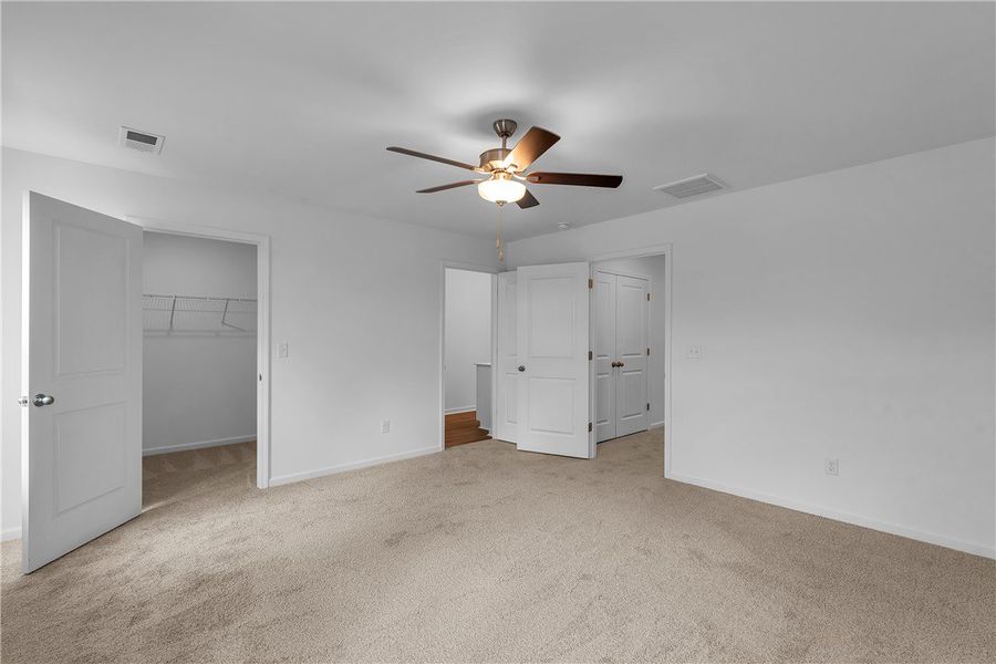 This spacious bedroom offers comfortable carpet fl This spacious bedroom offers comfortable carpet fl