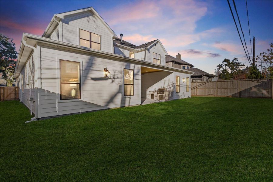 Out back, you’ve got a spacious, fully fenced yard with room to relax, play, or entertain. The covered patio is already set up for outdoor dinners or weekend grilling, making this space feel like a natural extension of your living area.