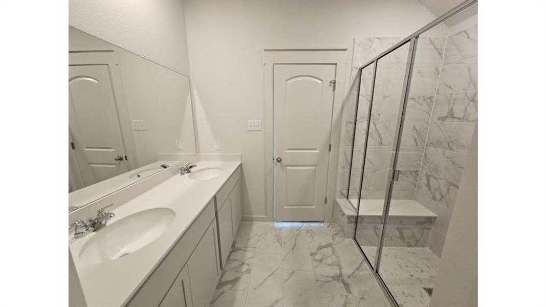 Dual sink vanity with white countertops and chrome fixtures