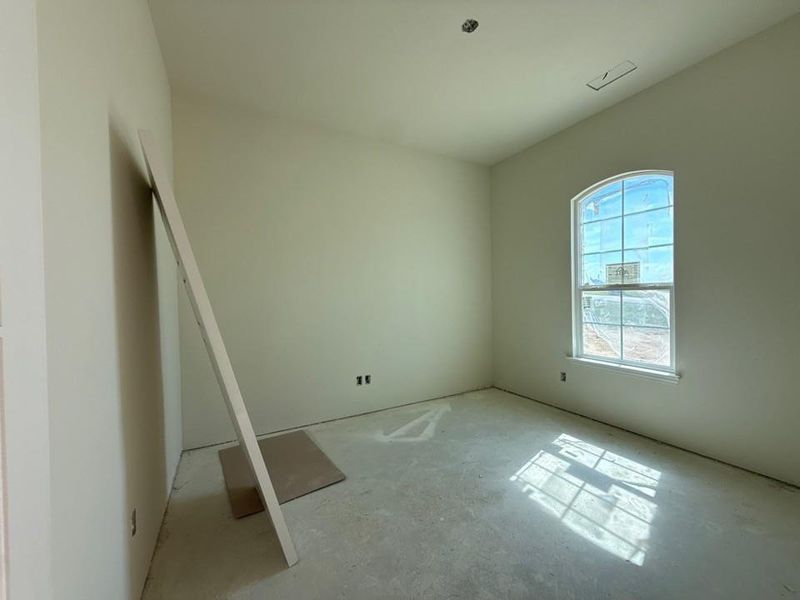 Arched window with grilles and white trim, recessed lighting rough-in, and ceiling air vent