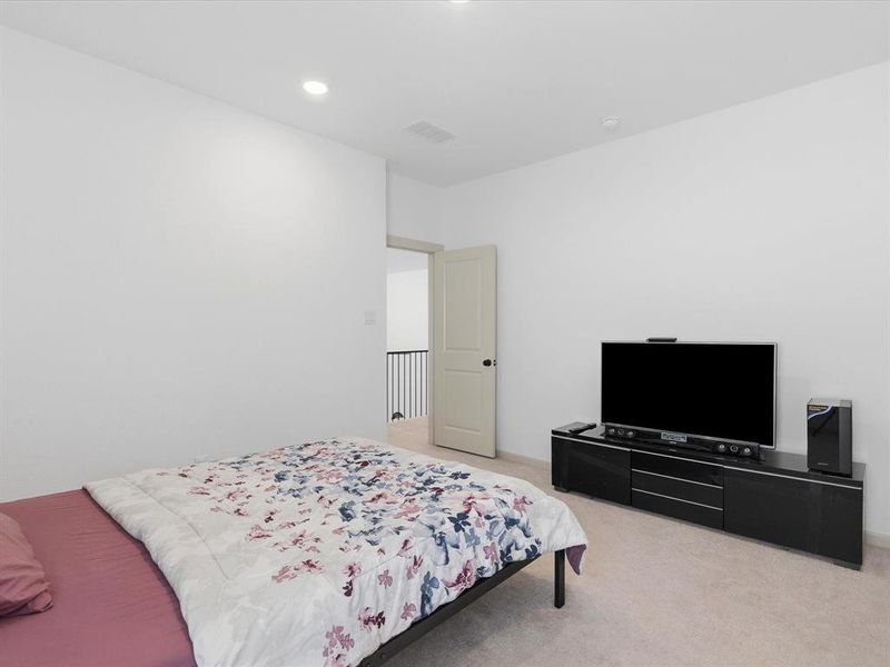 Room with light-colored carpeting and white wall finishes