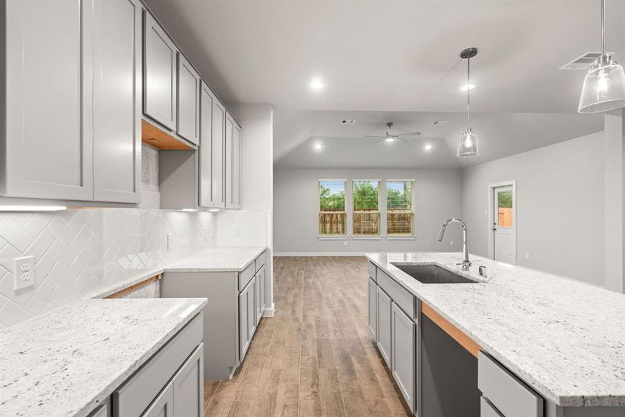 Discover another perspective of this stunning kitchen, generously appointed with an abundance of counter space. Representation. Actual color and selections can vary.