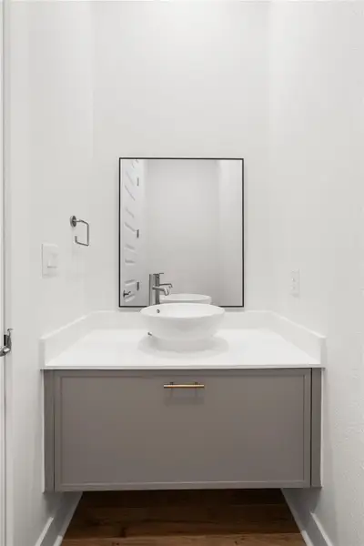 A sleek modern vanity with a vessel sink offers refined utility. A sleek modern vanity with a vessel sink offers refined utility.