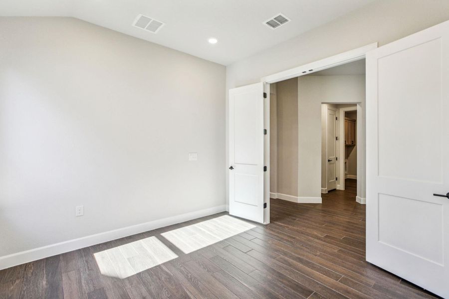 Empty room featuring dark wood finished floors and recessed lighting Empty room featuring dark wood finished floors and recessed lighting